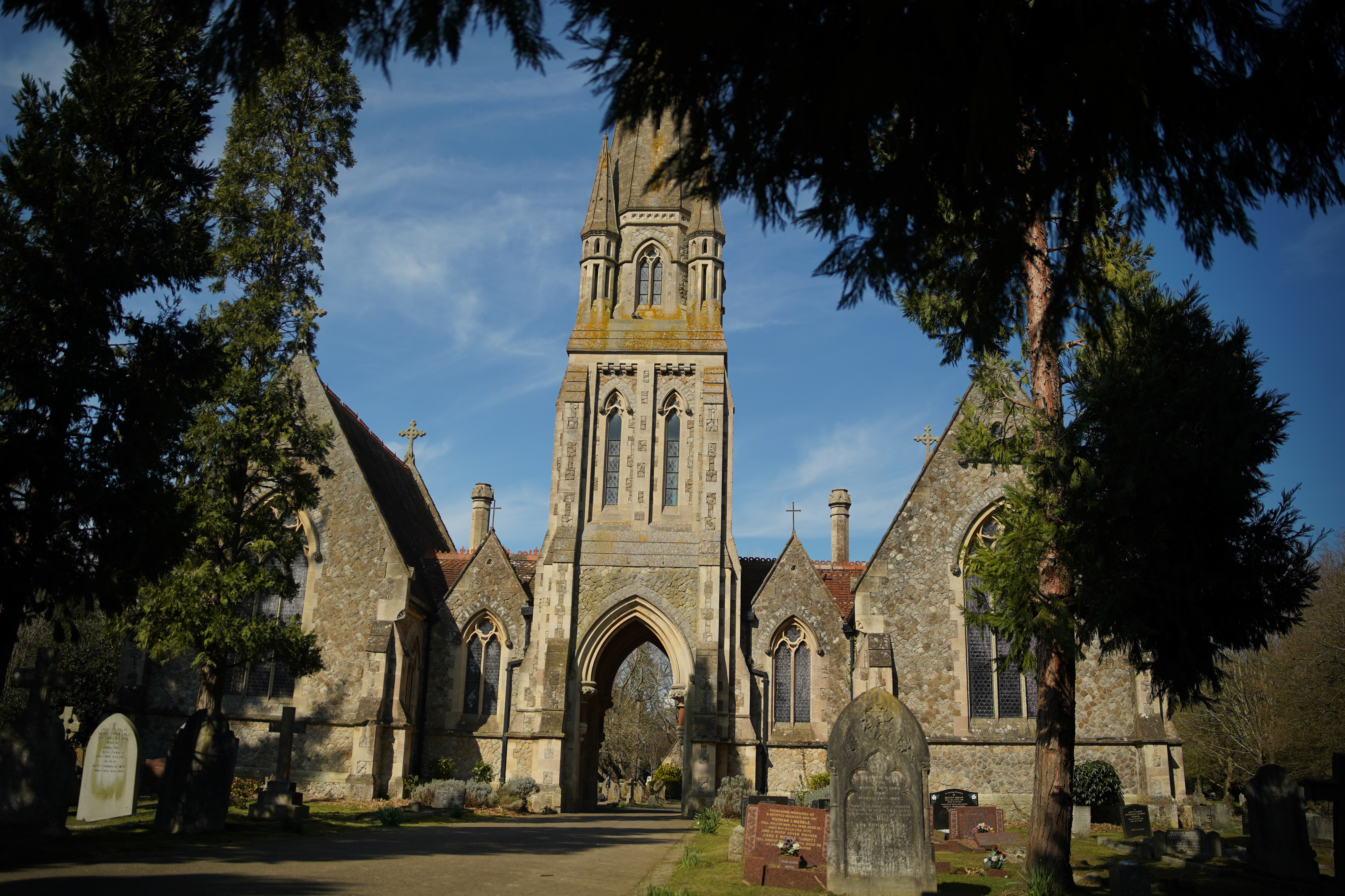 The archway of Canterbury Cemetery’s main building topped with an elegantly lofty spire and flanked by twin ragstone chapels.
